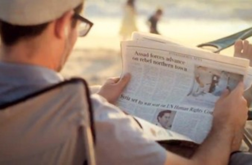 MAN reads a copy of ‘The Jerusalem Post’ (photo credit: YouTube screenshot)