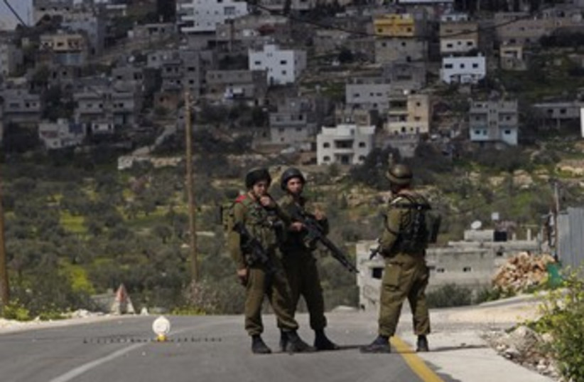 IDF soldiers at West Bank checkpoint 370 (photo credit: REUTERS/Ammar Awad)