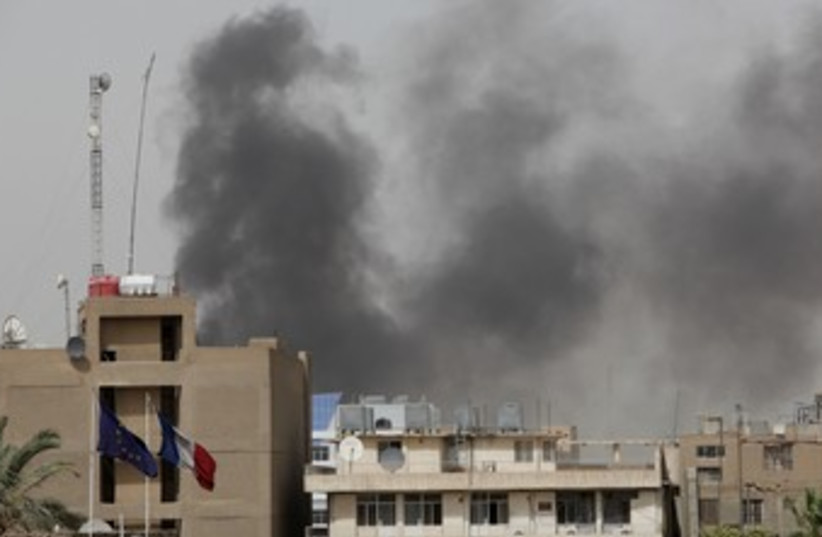 Smoke rises from the site of a bomb attack in Baghdad 370 (photo credit: REUTERS)