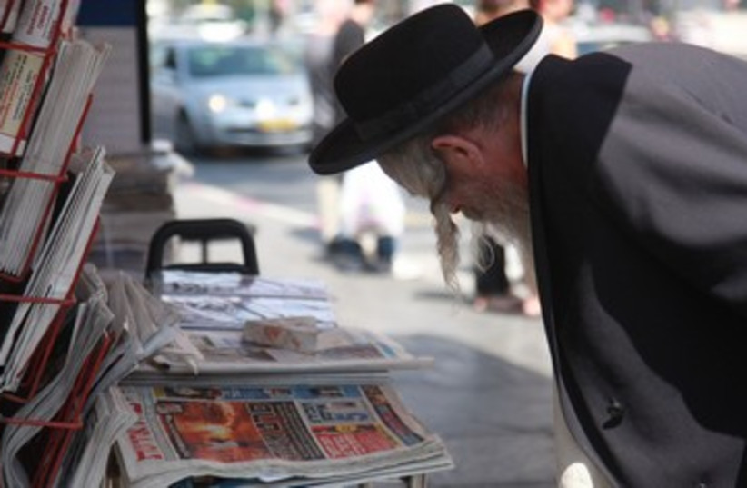 Orthodox haredi man reads newspapers media news 390 (photo credit: Marc Israel Sellem / The Jerusalem Post)