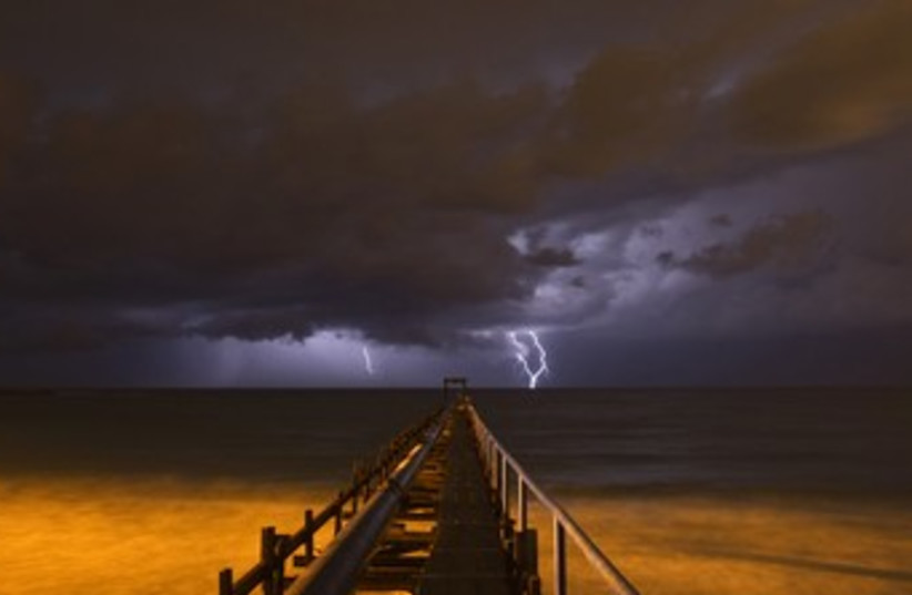 Storm, lightning rain sea thunder clouds 370 (R) (photo credit: Baz Ratner / Reuters)