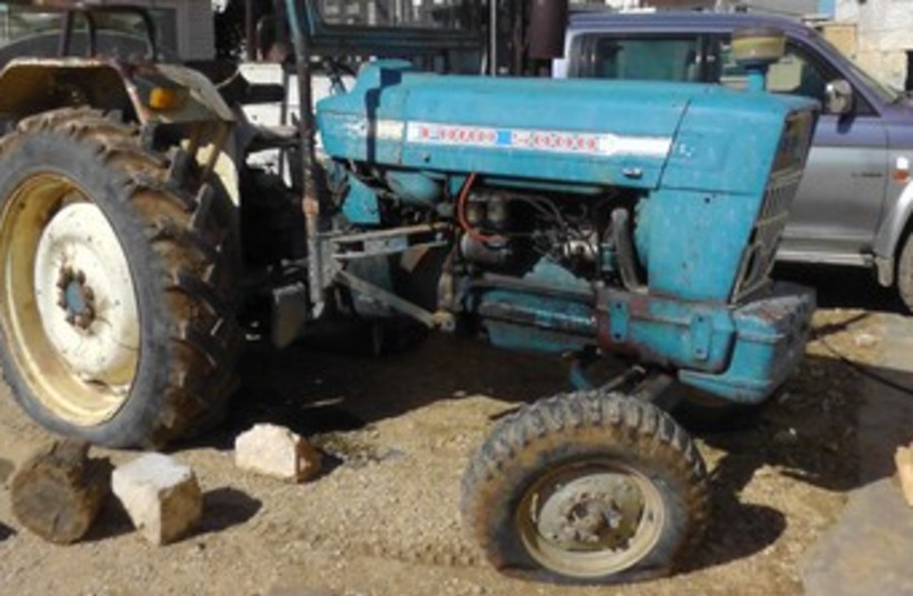 Tractor with tires slashed 370 (photo credit: Courtesy B'Tselem)