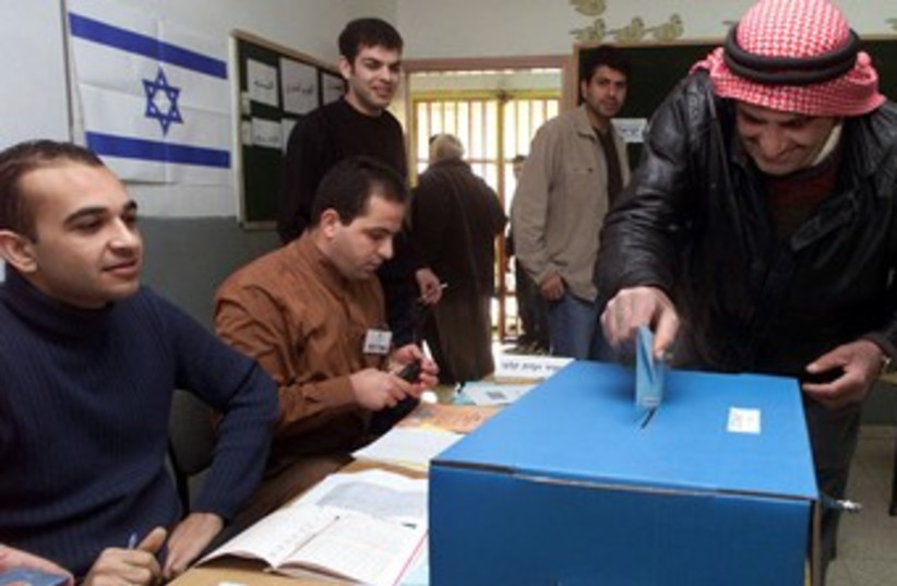 Israeli-Arab man casts his vote elections voting 370 (R) (photo credit: Ammar Awad / Reuters)