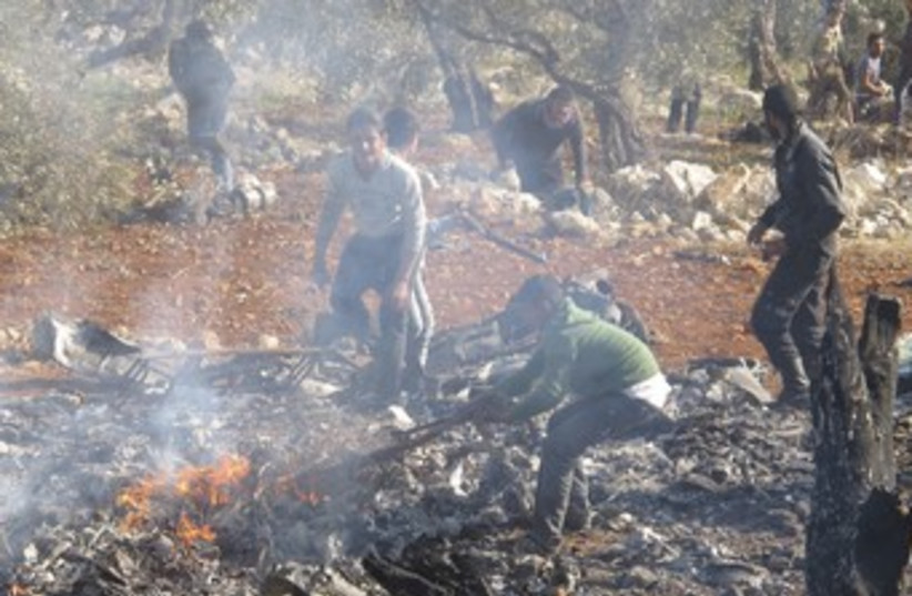 Burning wreckage of  Syrian warplane 370 (photo credit: REUTERS/Abdalghne Karoof)