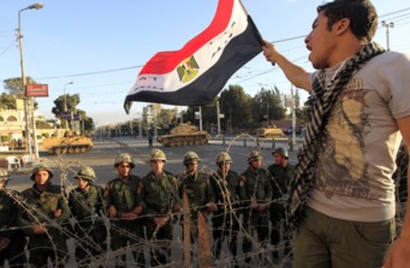 Egypt Revolution Part II Dec 2012 man with flag - 370 (photo credit: REUTERS)