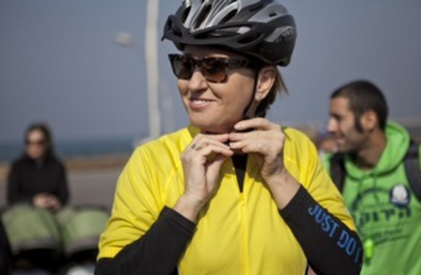 Tzipi Livni bikes with environmentalists 370 (photo credit: Courtesy of Sodavideo)
