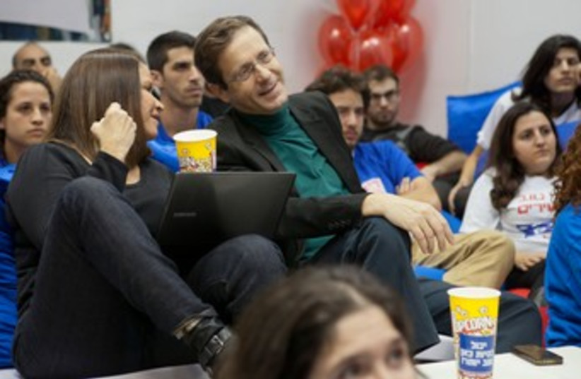 Shelly Yachimovich and Isaac Herzog watch election ads 370 (photo credit: Shai Skiff)