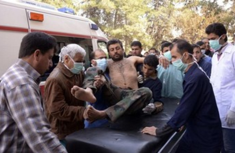 Syrian soldier injured in alleged chemical weapon attack 360 (photo credit: REUTERS/George Ourfalian)