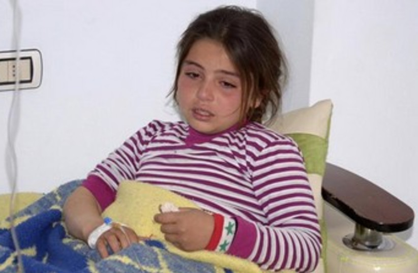 Girl allegedly hurt in Syria chemical weapon attack 370 (photo credit: REUTERS/George Ourfalian)