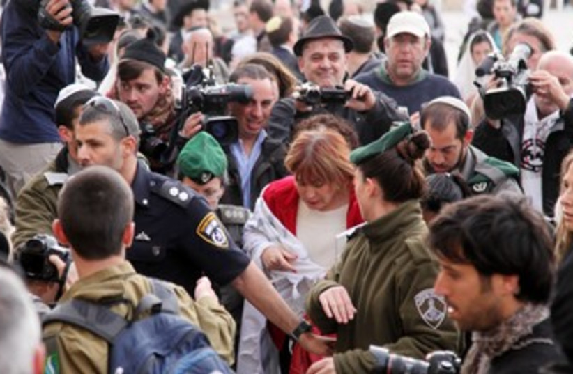 Law enforcement officials escort Women of the Wall director Lesley Sachs at the Western Wall in Jerusalem (file photo) (photo credit: Marc Israel Sellem)