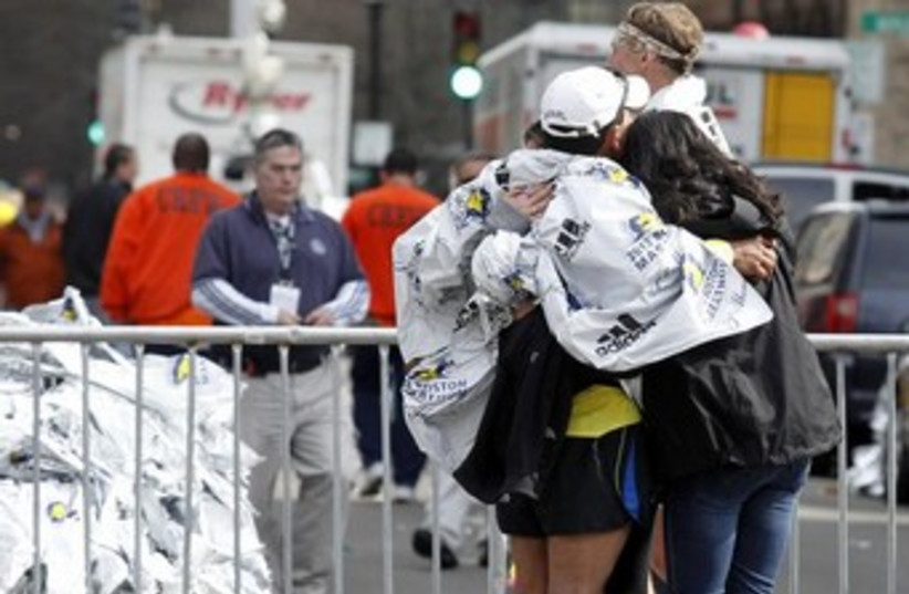 People comforting each other after Boston blast 370 (photo credit: REUTERS/Jessica Rinaldi)