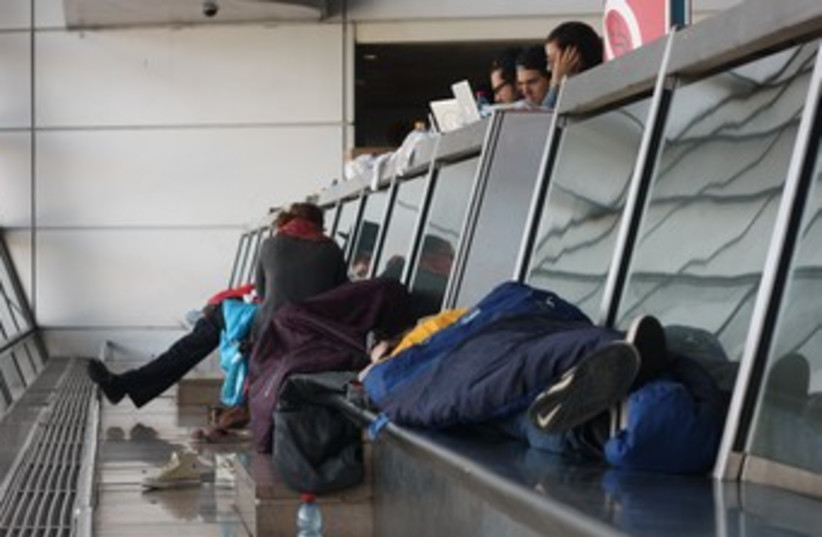 Passengers asleep at Ben Gurion airport during strike 370 (photo credit: Ben Hartman)