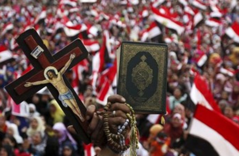 Christian and Muslim in Tahrir370 (photo credit: Reuters)