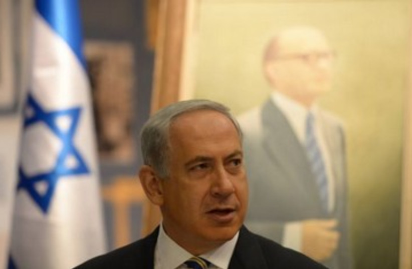 Netanyahu with Begin picture in background 370 (photo credit: courtesy Prime Minister's Office)