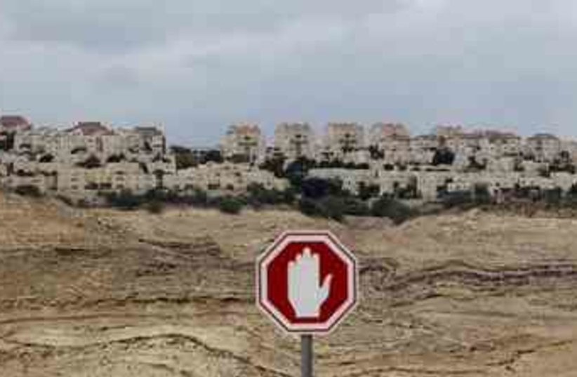 A stop sign is seen outside a West Bank Jewish settlement (photo credit: Reuters)