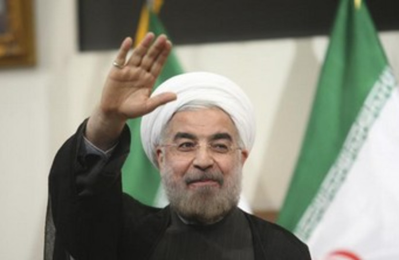 Hassan Rouhani Iran flag in background 370 (photo credit: REUTERS/Raheb Homavandi)