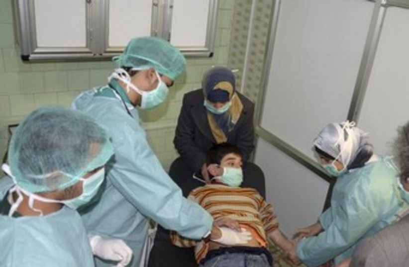 Boy affected by alleged chemical weapons attack in Syria 370 (photo credit: REUTERS)
