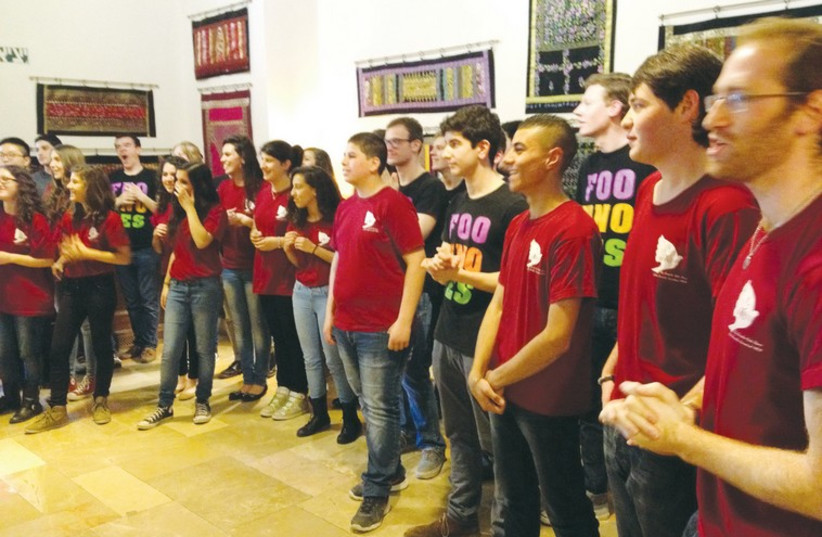 A joint Israeli and Palestinian youth choir at the YMCA sing together in an effort to build coexistence. (photo credit: BRIAN BLUM)