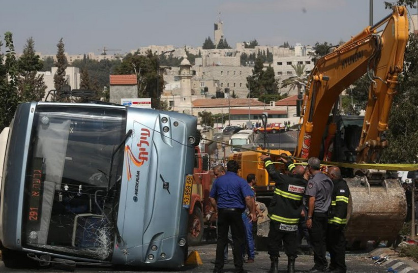 Bus flipped by tractor in Jerusalem terror attack (photo credit: MARC ISRAEL SELLEM/THE JERUSALEM POST)