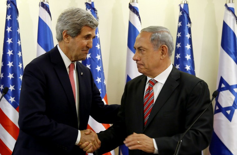Prime Minister Benjamin Netanyahu (R) shakes hands with US Secretary of State John Kerry (photo credit: REUTERS)