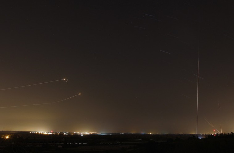 Rockets launched from Gaza Strip towards Israel is seen as rocket by Iron Dome anti-missile system is fired to intercept them (photo credit: REUTERS)