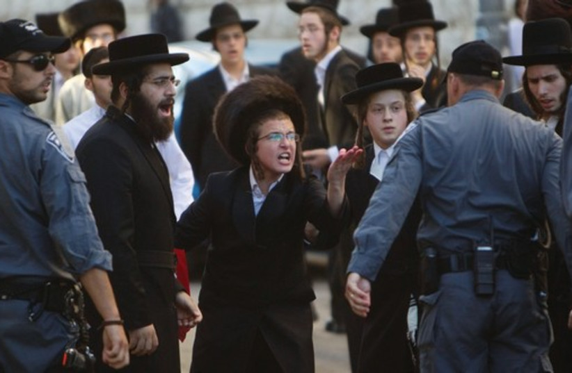 Haredim take part in a protest in Mea She’arim against the municipality opening a nearby road on Shabbat. (photo credit: REUTERS/BAZ RATNER)