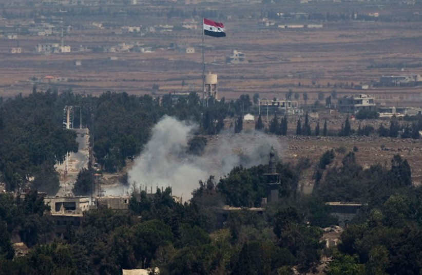 Smoke rises following an explosion on the Syrian side near the Quneitra border crossing between the Golan Heights and Syria, August 29, 2014. (photo credit: REUTERS)