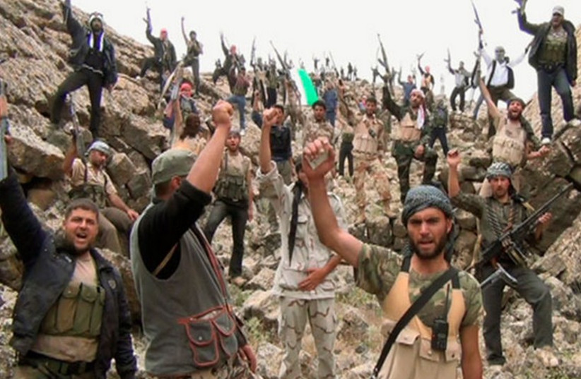 Syrian rebels fighting the Assad regime celebrate. (photo credit: REUTERS)