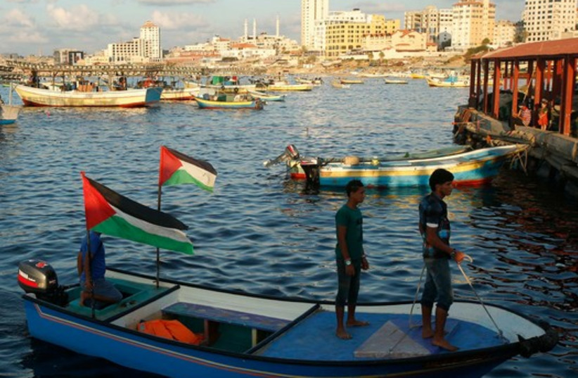 Palestinians stand atop a boat at Gaza's seaport in Gaza City October 16 (photo credit: REUTERS)