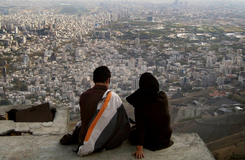 Iranian couple overlooks Tehran (photo credit: REUTERS)