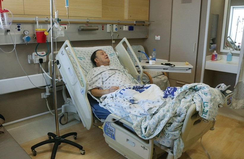 Man lying in a hospital bed at Hadassah University Medical Center in Jerusalem’s Ein Kerem [illustrative]. (photo credit: MARC ISRAEL SELLEM/THE JERUSALEM POST)