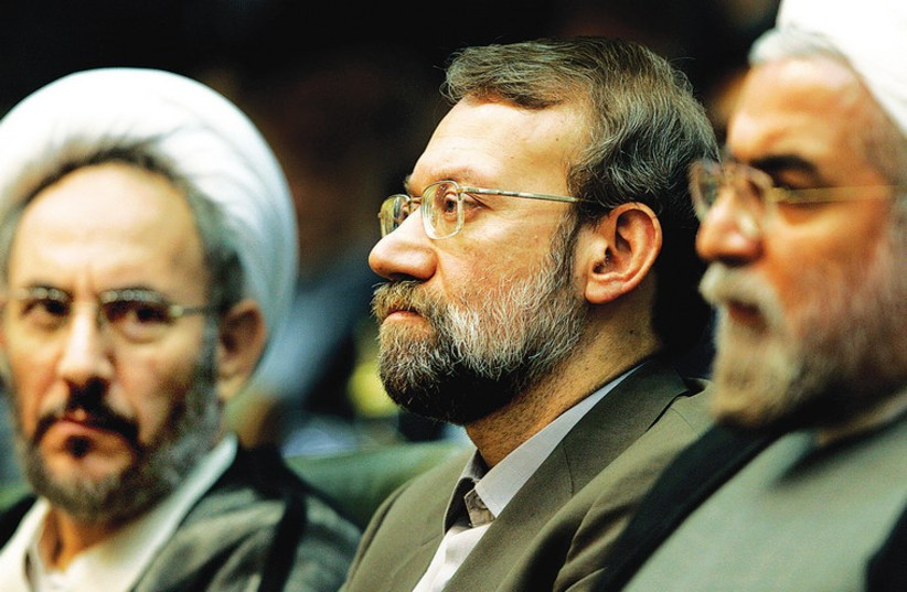Ali Younesi (center) with President Hassan Rouhani (right) and Ali Larijani, the current chairman of the Iranian parliament, at a conference on Iran’s Nuclear Policies and Prospects in Tehran in 2006. (photo credit: RAHEB HOMAVANDI/REUTERS)
