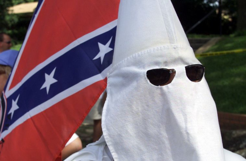 Ku Klux Klan members approach the Walls Unit in Huntsville, Texas. (photo credit: REUTERS)