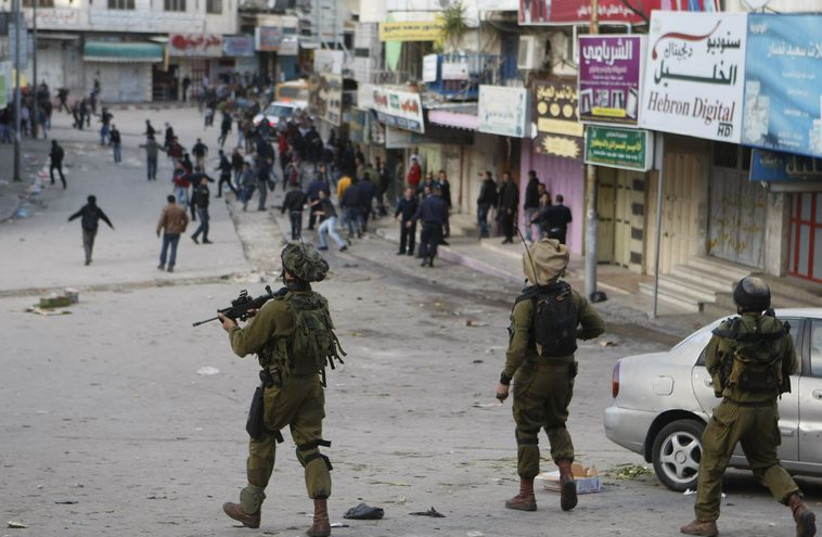 IDF soldiers in Hebron (photo credit: REUTERS)