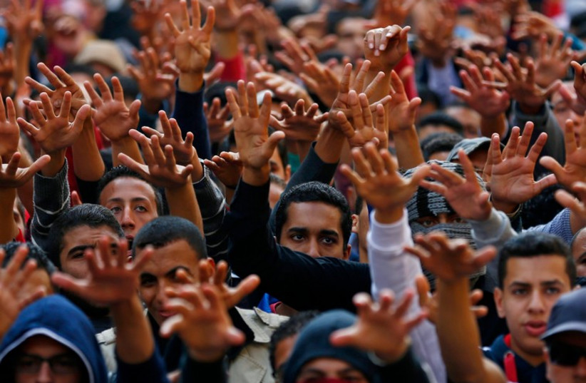 Cairo University students shout slogans against the government after the verdict of former Egyptian President Hosni Mubarak's trial (photo credit: REUTERS)