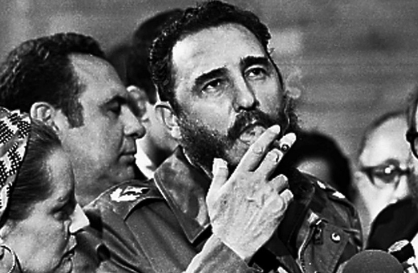 File picture of Fidel Castro smoking a cigar during interview with the press in Havana (photo credit: REUTERS)