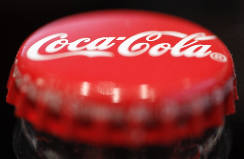 A logo is seen on a Coca-Cola bottle  (photo credit: REUTERS)