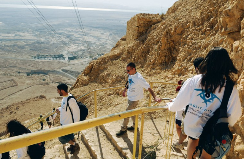 A TAGLIT-BIRTHRIGHT group climbs down the slope of Masada (photo credit: TAGLIT-BIRTHRIGHT)
