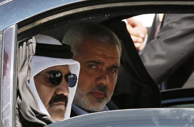 Hamas official Ismail Haniyeh (R) and the Emir of Qatar Sheikh Hamad bin Khalifa al-Thani arrive at a cornerstone laying ceremony in the southern Gaza Strip (photo credit: REUTERS)