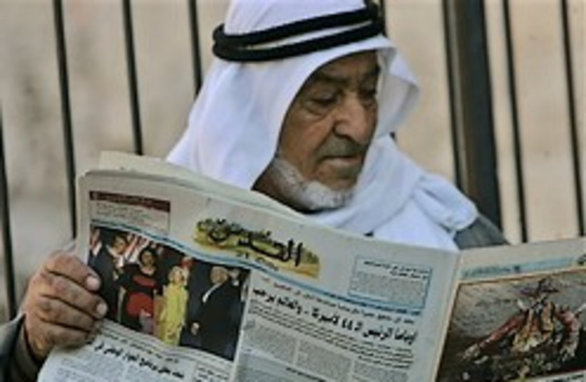 arab man reading paper 248.88 ap (photo credit: AP)