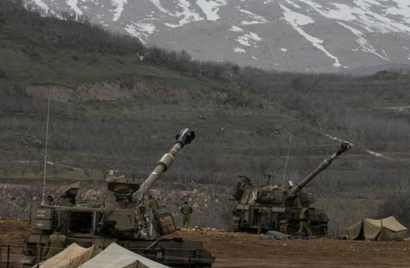 IDF soldiers near the border with Syria in the Golan Heights  (photo credit: REUTERS)