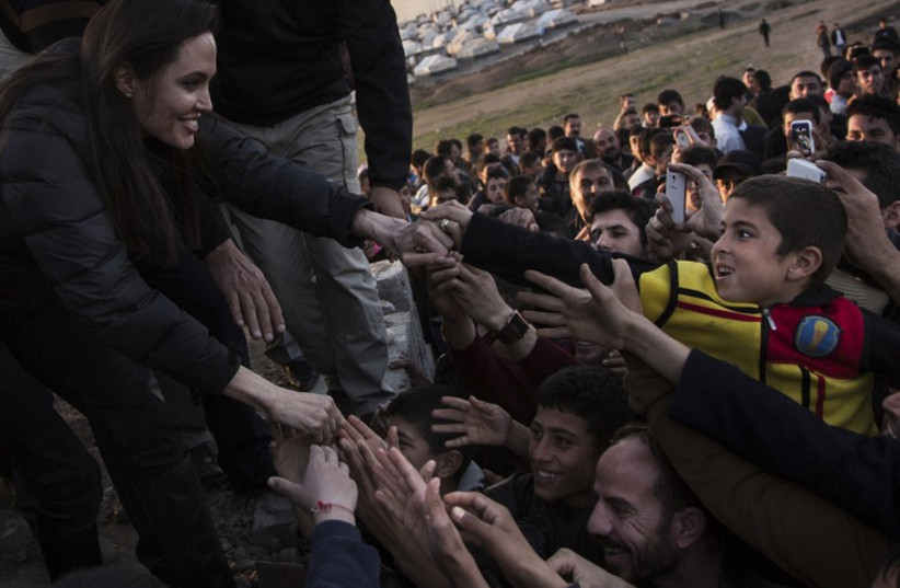 United Nations High Commissioner for Refugees (UNHCR) Special Envoy Angelina Jolie meets members of the Yazidi minority in Khanke internally displaced person (IDP) Camp in Dohuk, northern Iraq January 25, 2015. (photo credit: REUTERS)