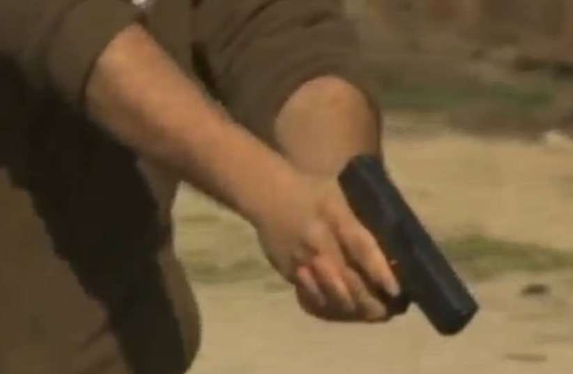 A man holding a gun. (photo credit: screenshot)