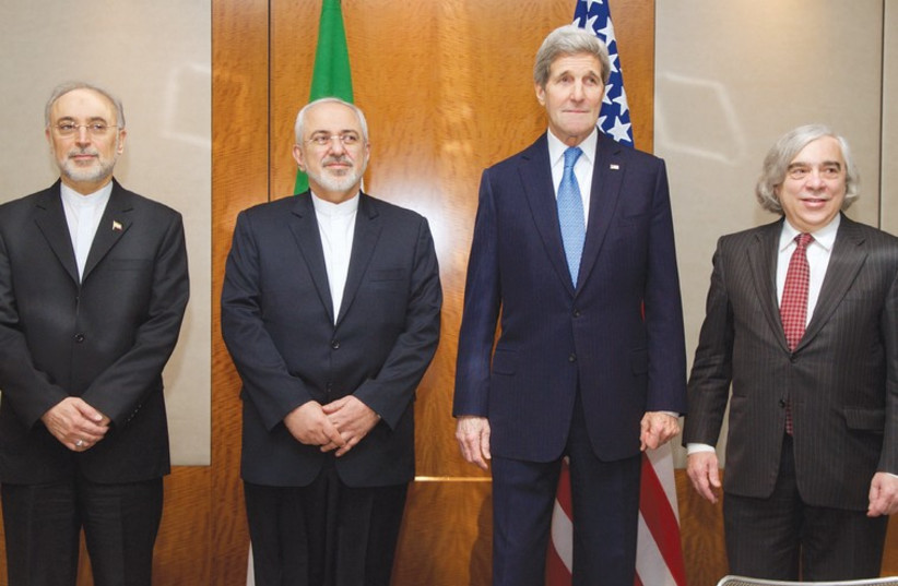US AND IRANIAN negotiators pose yesterday in Geneva before another discussion of Iran’s nuclear program (photo credit: REUTERS)