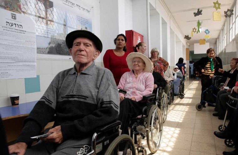 Elderly Israelis wait for their turn to vote  (photo credit: REUTERS)