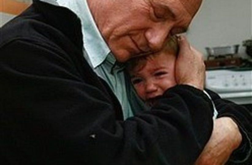 olmert hugging kid 248.88 (photo credit: AP)