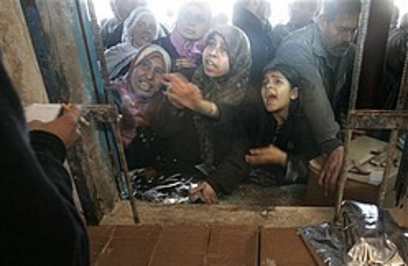 Palestinian receive food aid 248.88 (photo credit: AP [file])