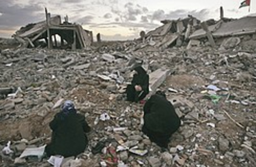 Palestinian women sit in rubble 248.88 (photo credit: AP)