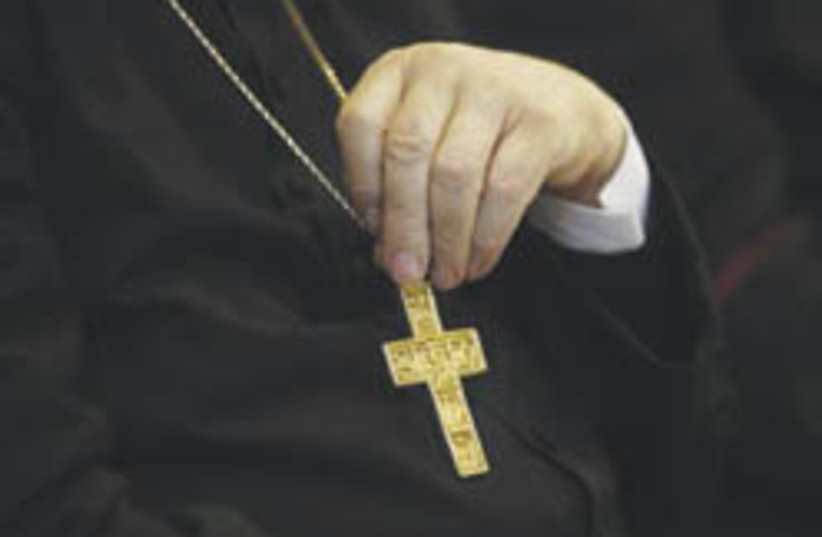 hand with crucifix  (photo credit: AP)