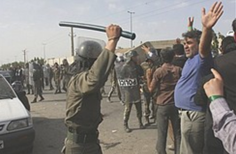 Iran police hit protesters  248.88 (photo credit: AP)